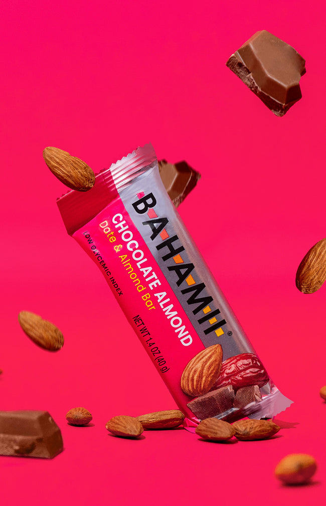 Bahami chocolate almond date almond bar healthy snack pink background almonds chocolate pieces