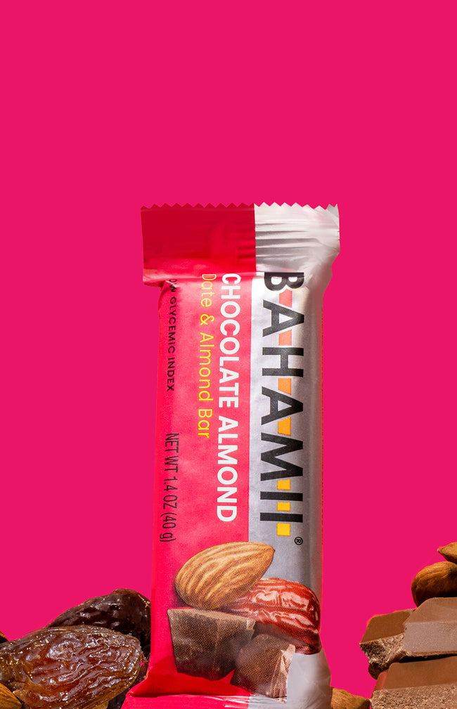 chocolate almond date almond bar healthy snack Bahamii protein bar pink background