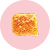 piece of baklava dessert on pink background