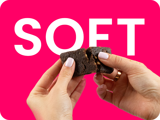 soft brownie being broken apart by hands