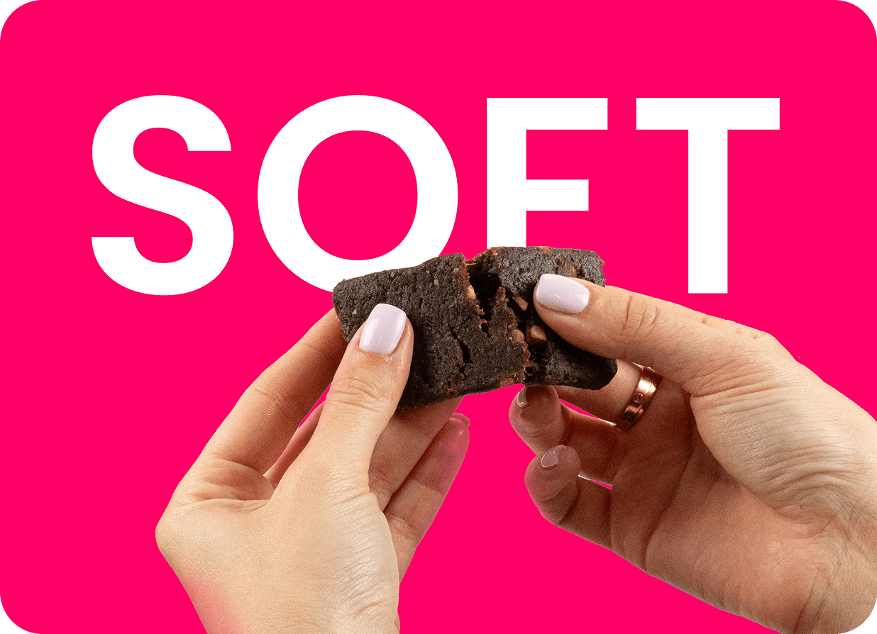 soft chocolate brownie being broken in hands