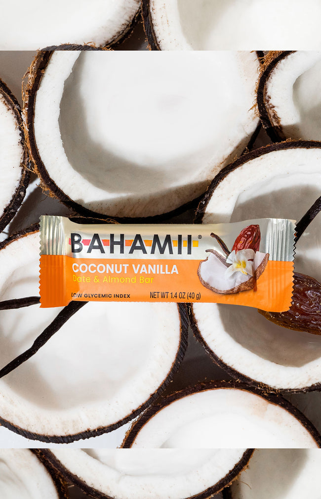 Bahami coconut vanilla date almond bar on halved coconuts